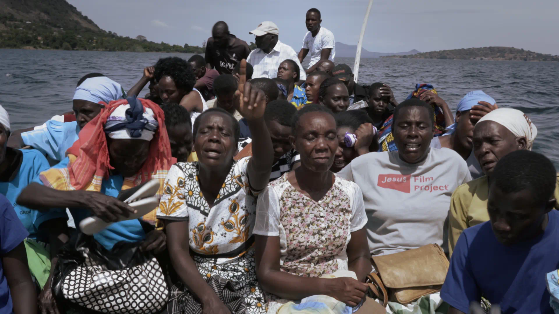 Women mourn in a boat carrying the coffin of a young woman in Lake Victoria, Kenya