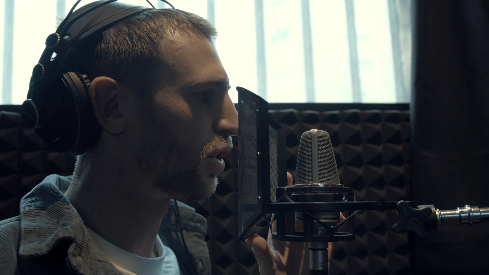 Timothee Adolphe in the studio rapping